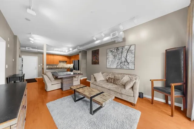 a living room with furniture a rug and a flat screen tv