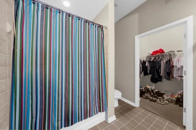 a bedroom with a bed and dresser with mirror