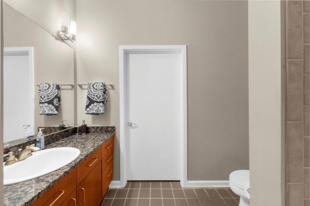 5300 Peachtree Road, Unit 1608 Chamblee, GA 30341 - Photo 29 of 47 a bathroom with a granite countertop sink and a mirror