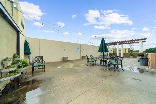a view of a patio with a table and chairs