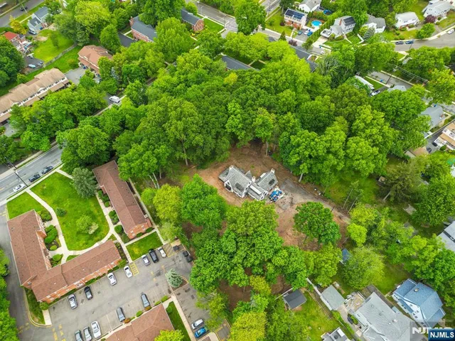 an aerial view of a house with a yard and lake view