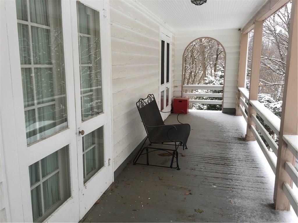 2 Sets of french doors from Living and Dining Room to covered side porch.  Porch views are woods and Avonworth Park. 