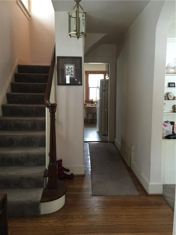Generous entry.  Hardwood in good condition.  2x2 entry with 1/2 bath.