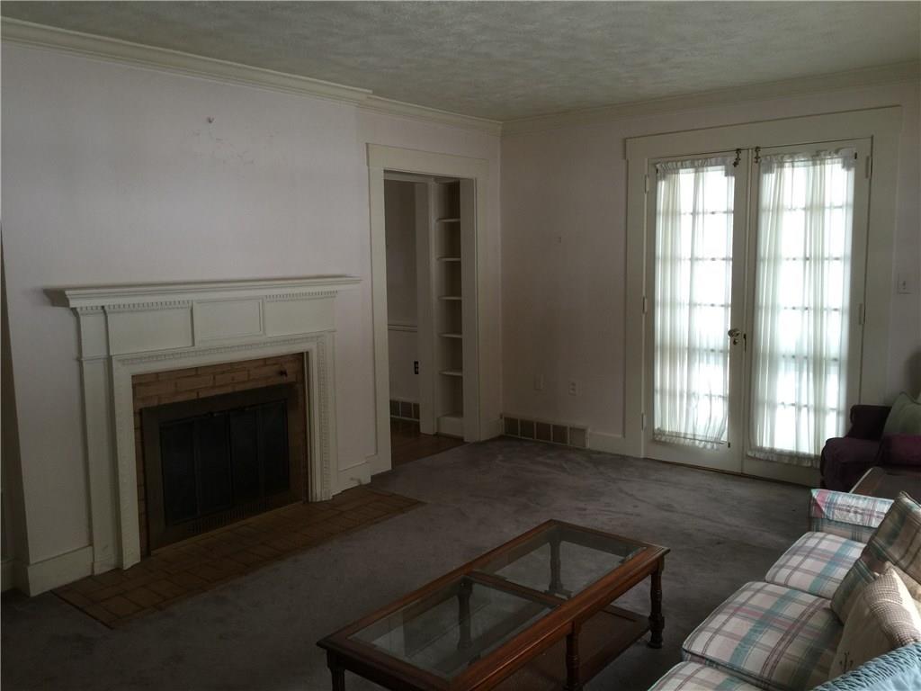 Wood fireplace.  Built-ins on left side.  Crown Moulding adds character along with built ins around entry to dining room.