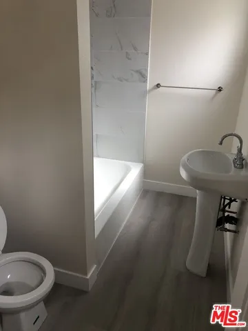a bathroom with a shower and toilet