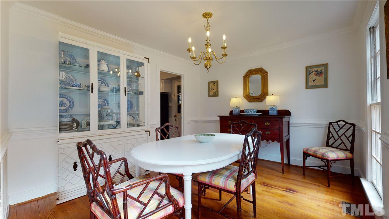 8101 Calais Court Raleigh, NC 27613 - Photo 11 of 24 a view of a dining room with furniture and chandelier