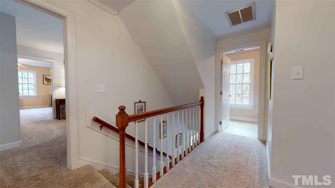 8101 Calais Court Raleigh, NC 27613 - Photo 13 of 24 a view of a hallway with a livingroom and stairs