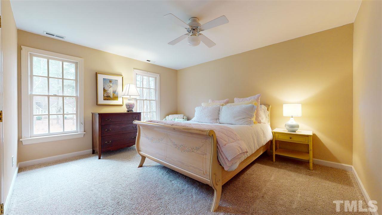 8101 Calais Court Raleigh, NC 27613 - Photo 14 of 24 a bedroom with a bed dresser and a window