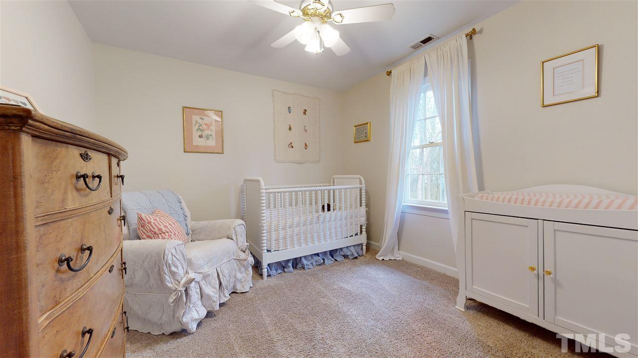 8101 Calais Court Raleigh, NC 27613 - Photo 15 of 24 a bedroom with furniture and a window