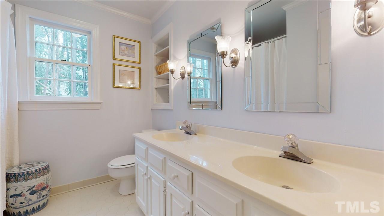 8101 Calais Court Raleigh, NC 27613 - Photo 16 of 24 a bathroom with a sink and a toilet