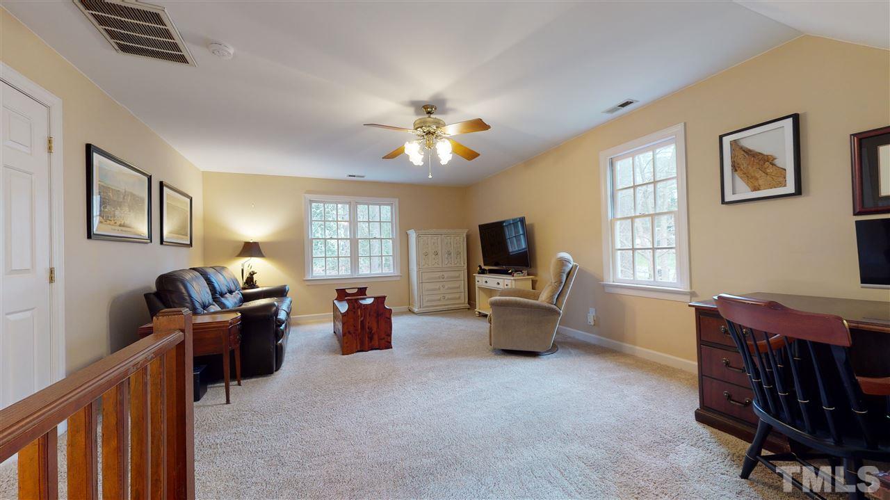 8101 Calais Court Raleigh, NC 27613 - Photo 19 of 24 a living room with furniture and a flat screen tv