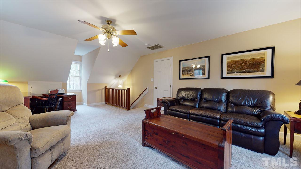 8101 Calais Court Raleigh, NC 27613 - Photo 20 of 24 a living room with couches a fireplace and a window