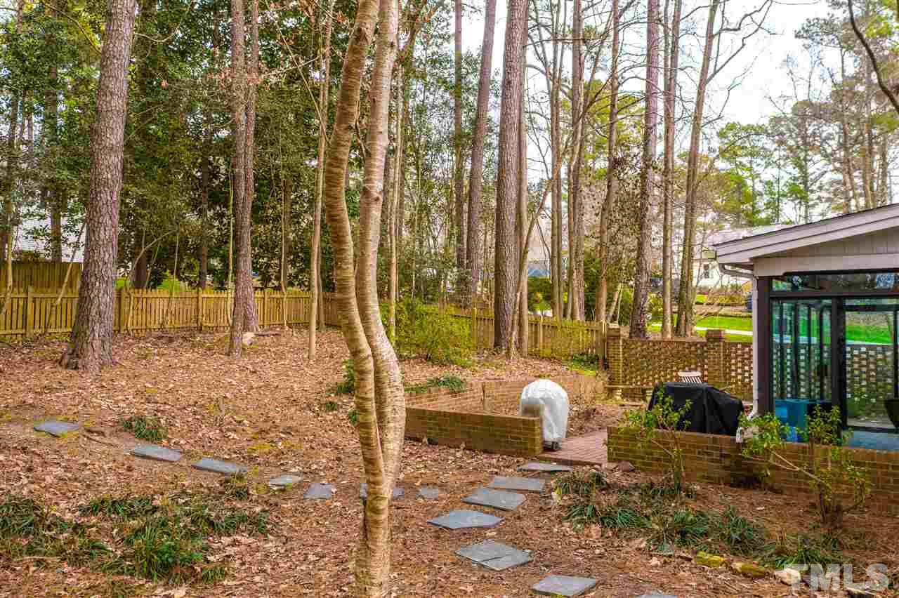 8101 Calais Court Raleigh, NC 27613 - Photo 22 of 24 a backyard of a house with table and chairs