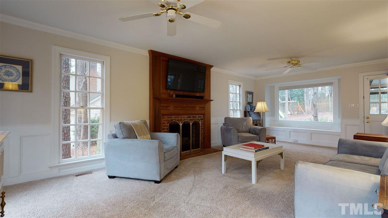 8101 Calais Court Raleigh, NC 27613 - Photo 5 of 24 a living room with furniture and a fireplace