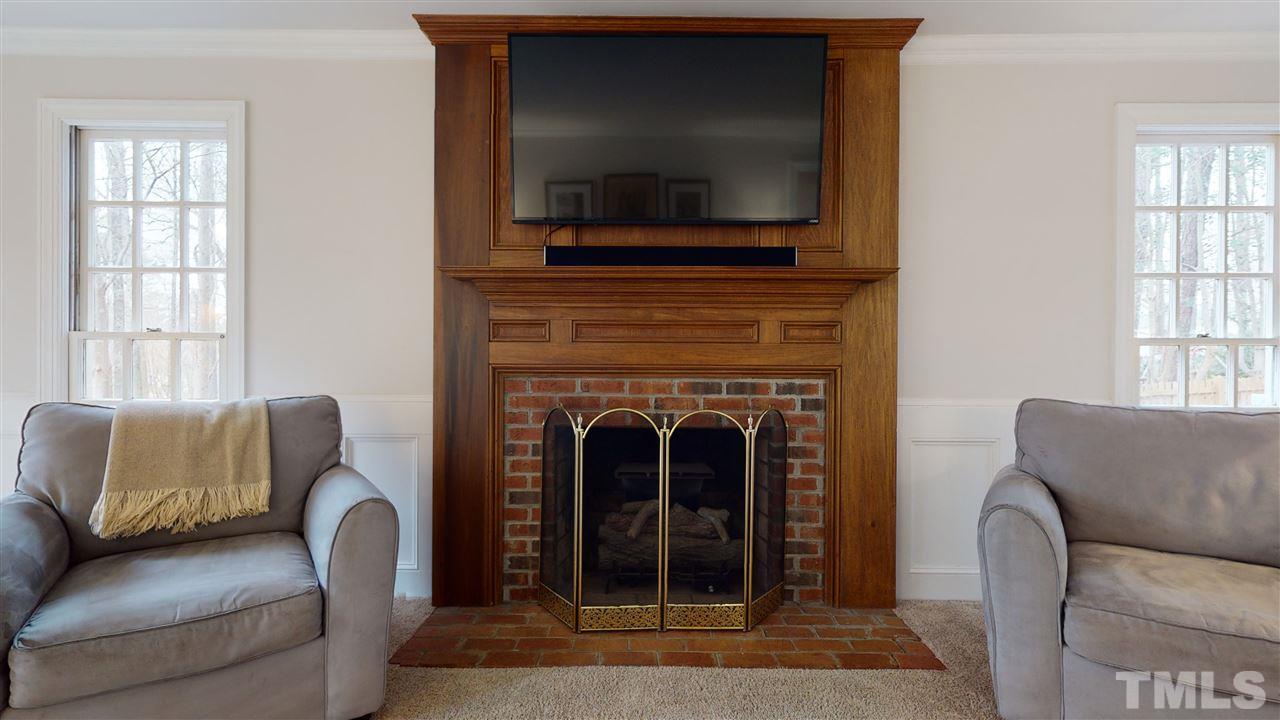 8101 Calais Court Raleigh, NC 27613 - Photo 6 of 24 a living room with furniture and a flat screen tv