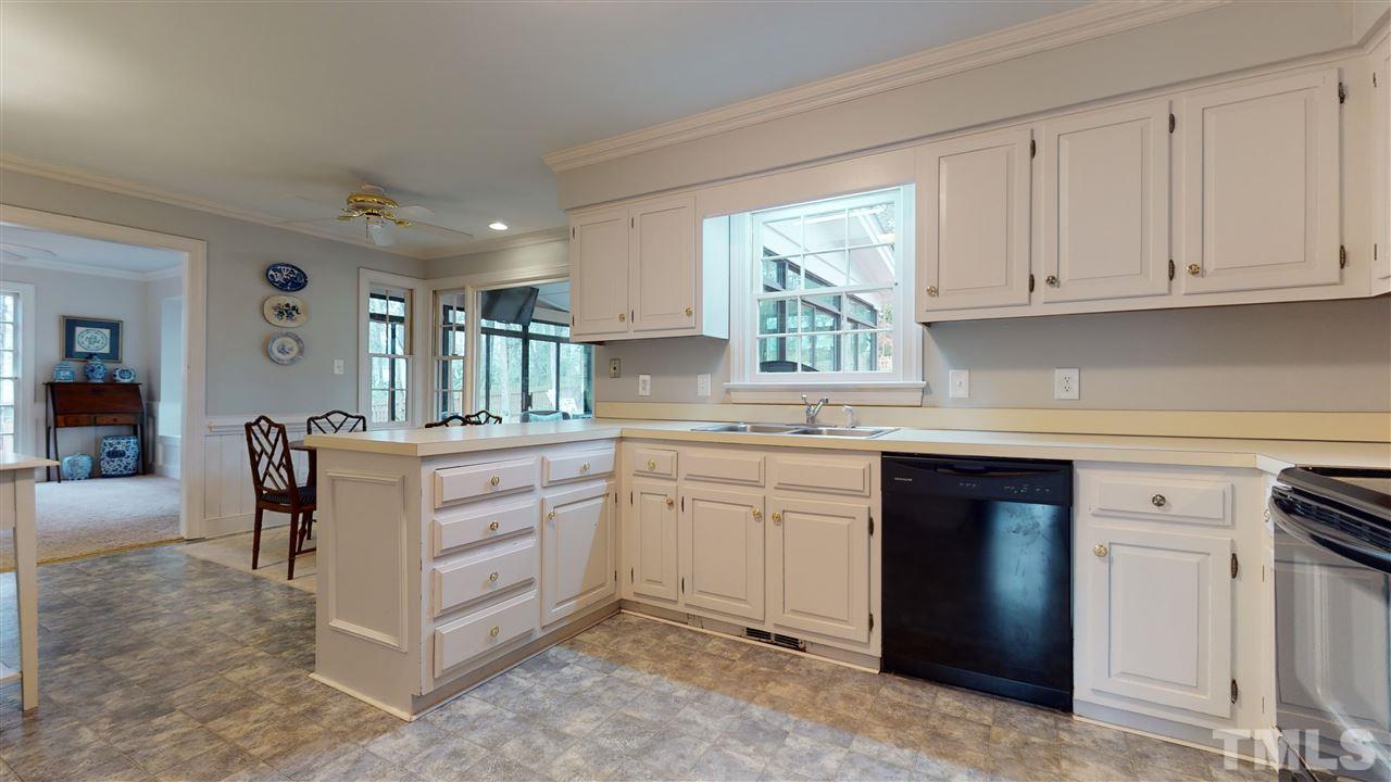 8101 Calais Court Raleigh, NC 27613 - Photo 9 of 24 a kitchen with cabinets appliances and a window