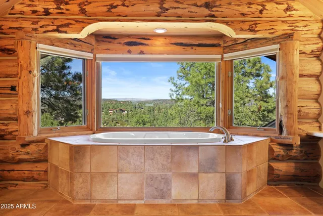 a white bath tub sitting in front of a window
