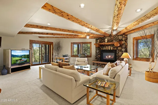 a living room with furniture and a ceiling fan