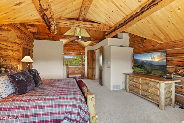 a bedroom with furniture and flat screen tv