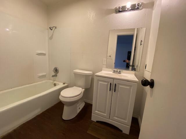 1310 54th Street, Unit 3 Lubbock, TX 79412 - Photo 7 of 8 a white toilet sitting next to a bathroom sink and tub