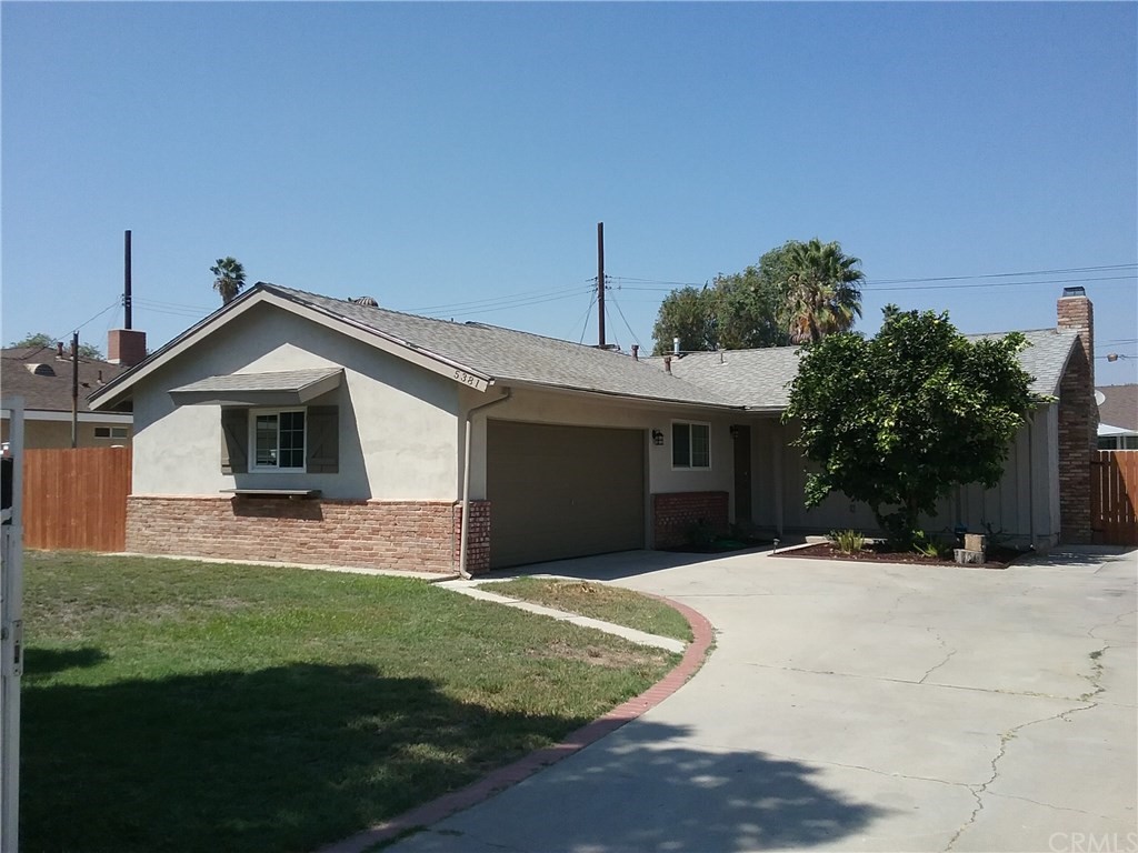 5381 Central Avenue Riverside, CA 92504 - Photo 1 of 1 a front view of a house with a yard and garage