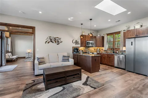 a kitchen with stainless steel appliances granite countertop a sink stove and microwave
