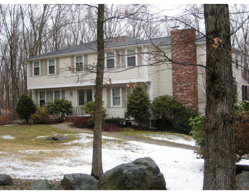 74 Bishop Road Sharon, MA 02067 - Photo 1 of 1 a view of a white house with a large tree next to a yard and plants