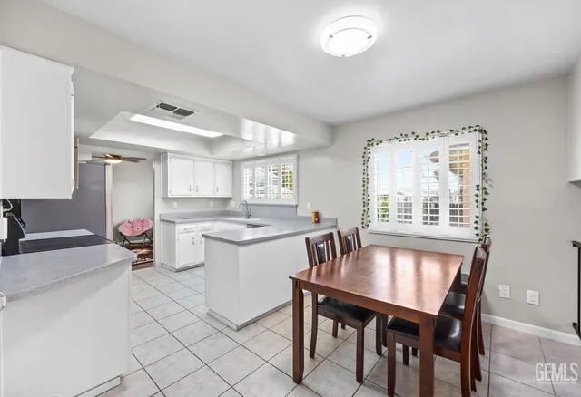 a kitchen with a table chairs and microwave