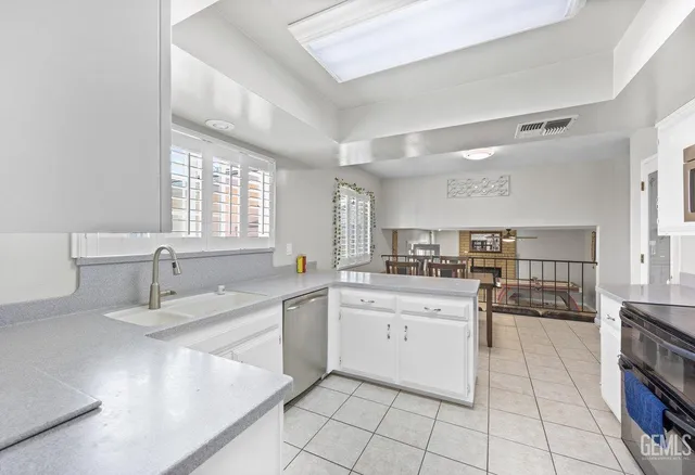 a kitchen with a sink stove and cabinets