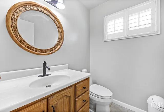 a bathroom with a toilet a sink and a mirror