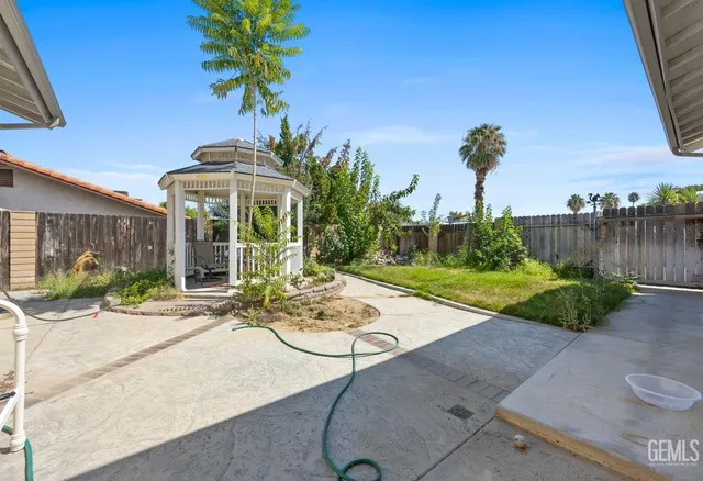 a view of a chair and table in backyard
