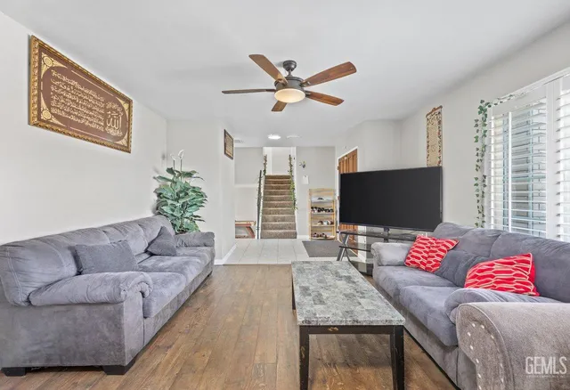 a living room with furniture and a flat screen tv