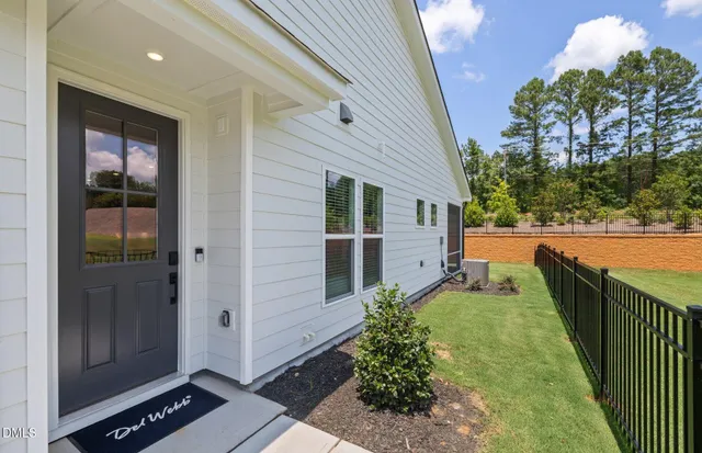 a view of a house with a backyard and a patio