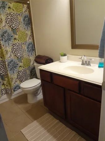 a kitchen with stainless steel appliances granite countertop a stove a sink dishwasher a refrigerator and a dining table with wooden floor