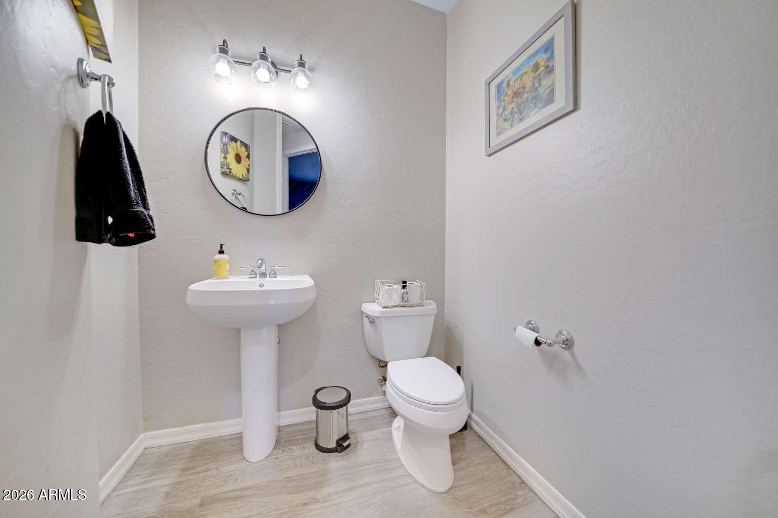 3978 East Hashknife Road Phoenix, AZ 85050 - Photo 12 of 29 a bathroom with a toilet sink and mirror