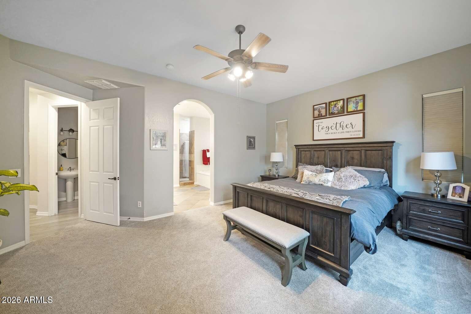 3978 East Hashknife Road Phoenix, AZ 85050 - Photo 14 of 29 a bedroom with a bed and a chandelier