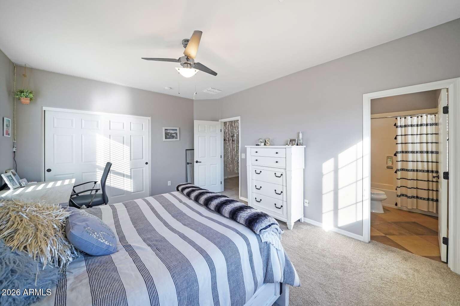 3978 East Hashknife Road Phoenix, AZ 85050 - Photo 17 of 29 a bedroom with a bed and a chandelier
