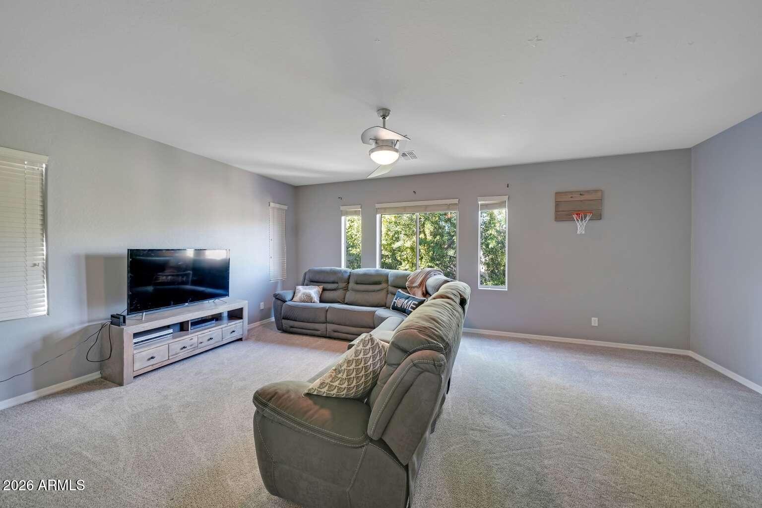 3978 East Hashknife Road Phoenix, AZ 85050 - Photo 20 of 29 a living room with furniture and a flat screen tv