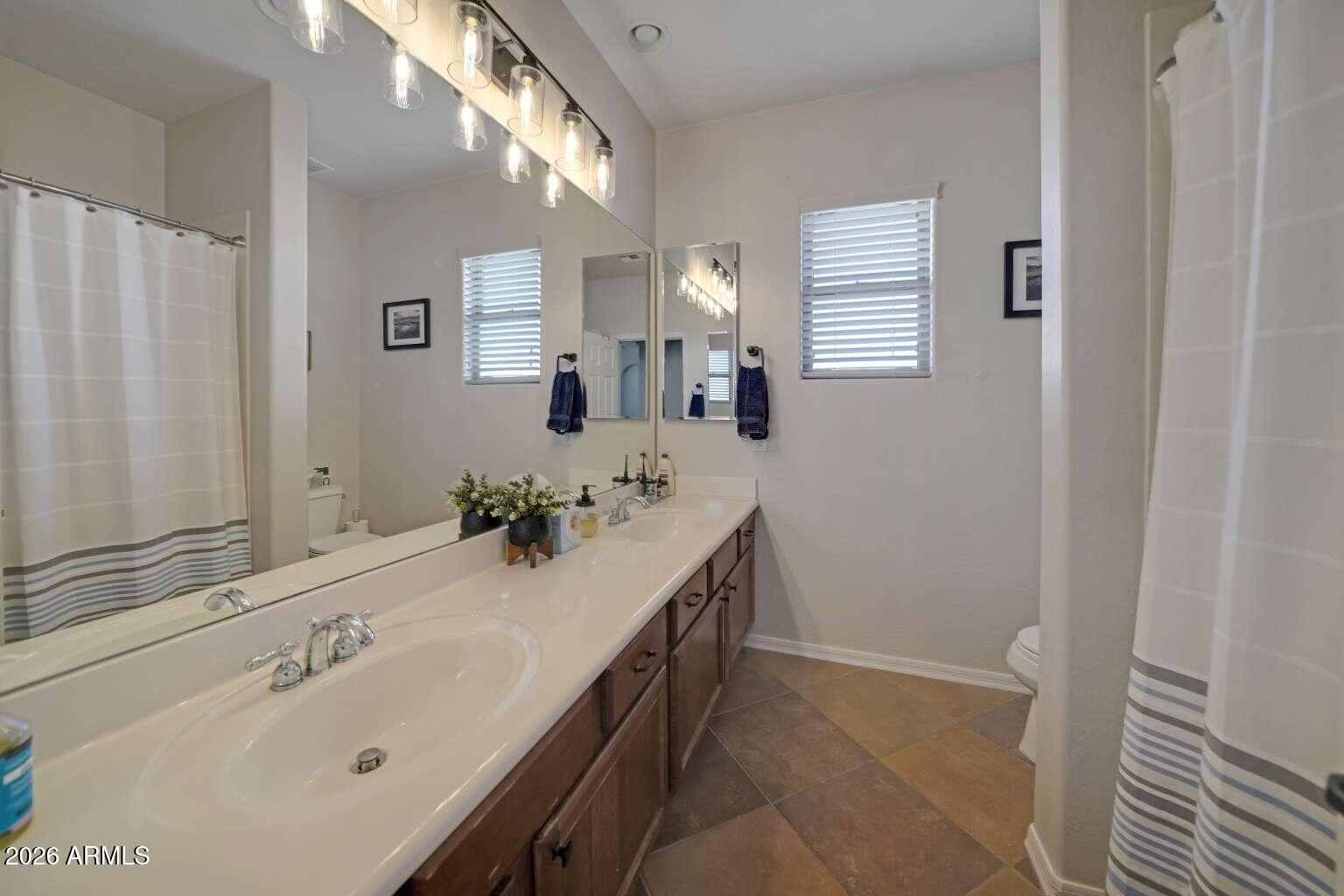 3978 East Hashknife Road Phoenix, AZ 85050 - Photo 23 of 29 a bathroom with a double vanity sink and a mirror