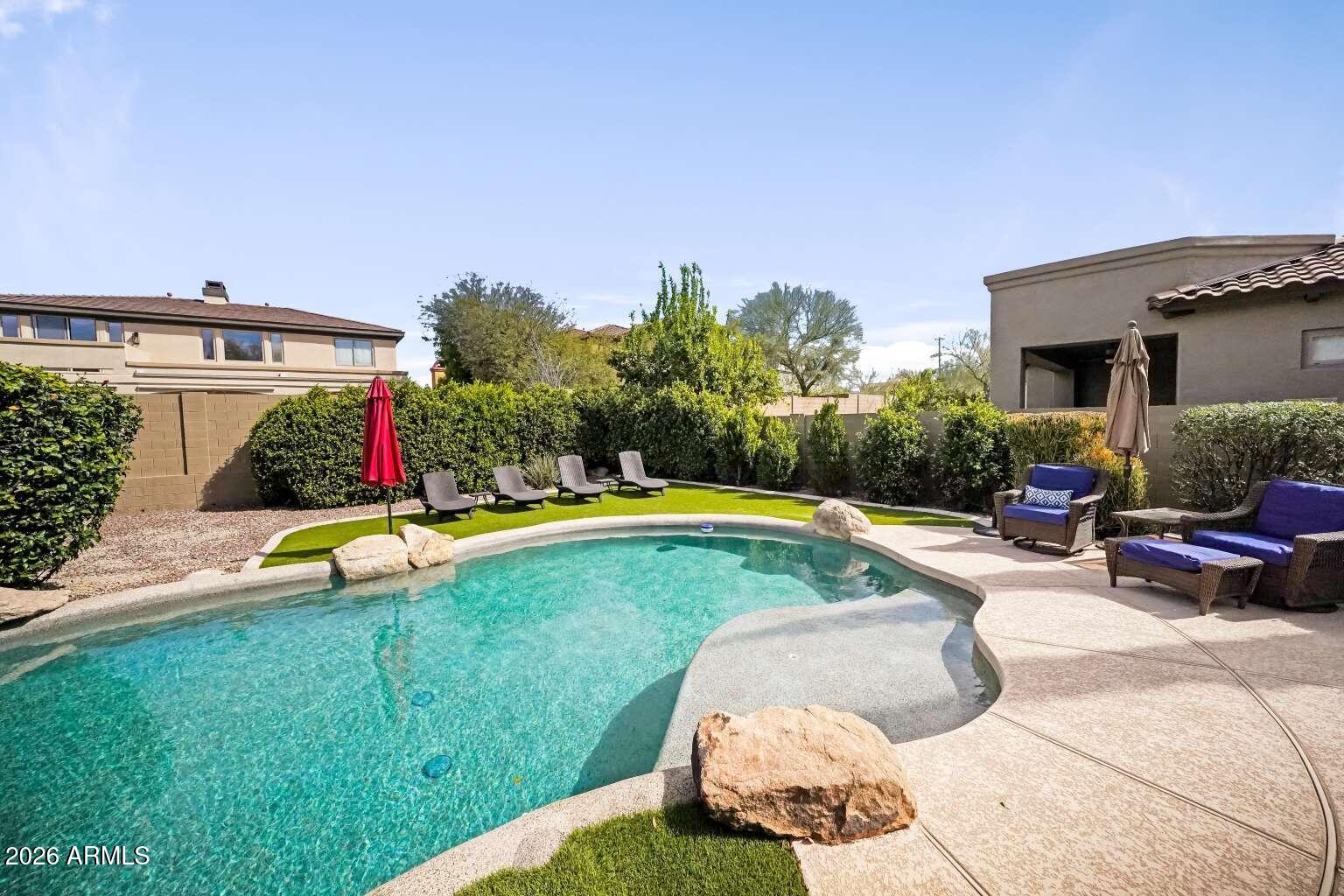 3978 East Hashknife Road Phoenix, AZ 85050 - Photo 27 of 29 a view of swimming pool with umbrella and wooden fence