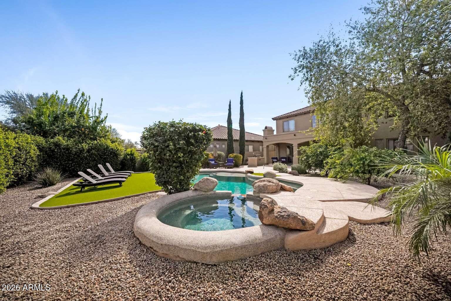 3978 East Hashknife Road Phoenix, AZ 85050 - Photo 29 of 29 a view of a swimming pool with a chairs and potted plants