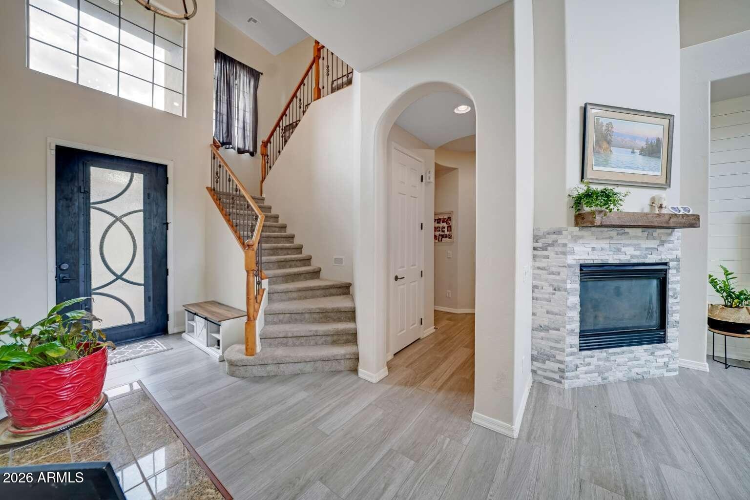 3978 East Hashknife Road Phoenix, AZ 85050 - Photo 5 of 29 a view of an entryway with wooden floor and a fire place