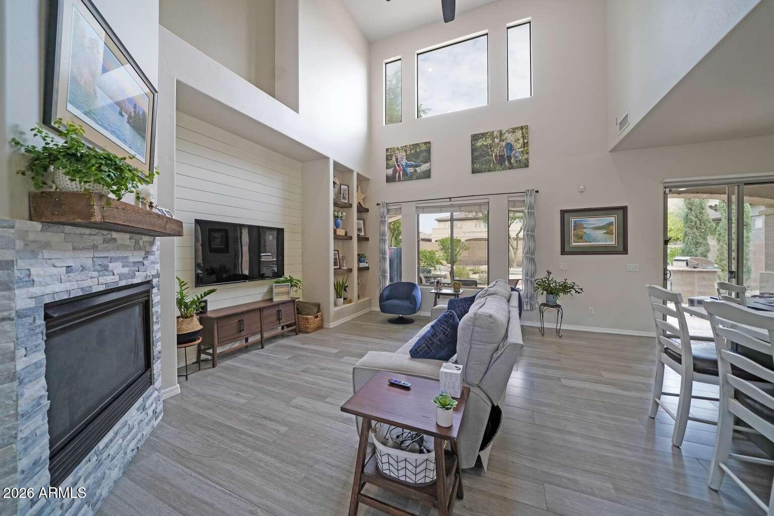 3978 East Hashknife Road Phoenix, AZ 85050 - Photo 6 of 29 a living room with furniture a flat screen tv and a fireplace