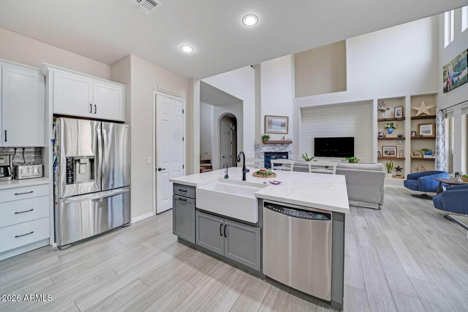 3978 East Hashknife Road Phoenix, AZ 85050 - Photo 10 of 29 a kitchen with kitchen island white cabinets and stainless steel appliances