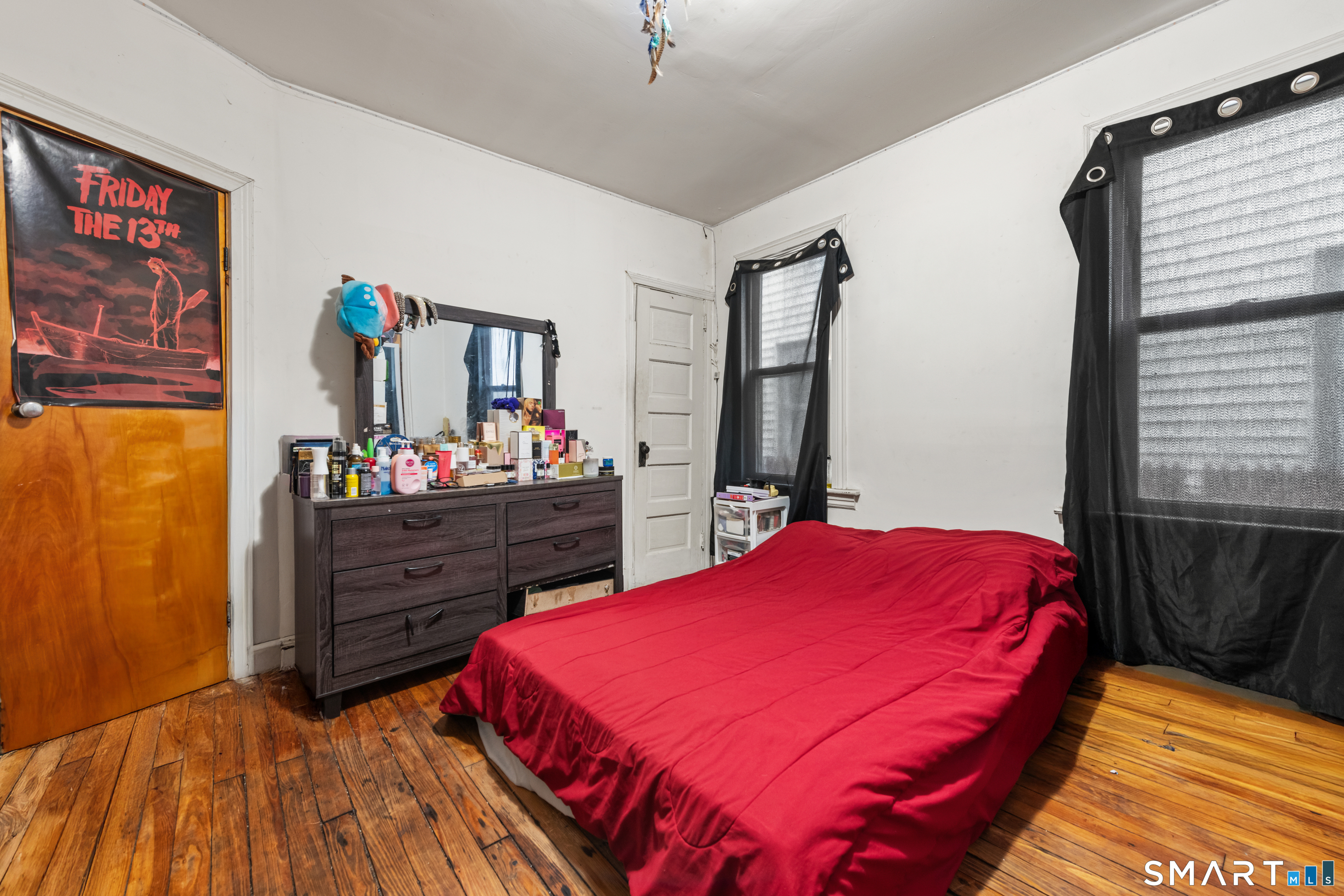 386 Huntington Road Bridgeport, CT 06608 - Photo 11 of 33 a bed room with a bed and a dresser
