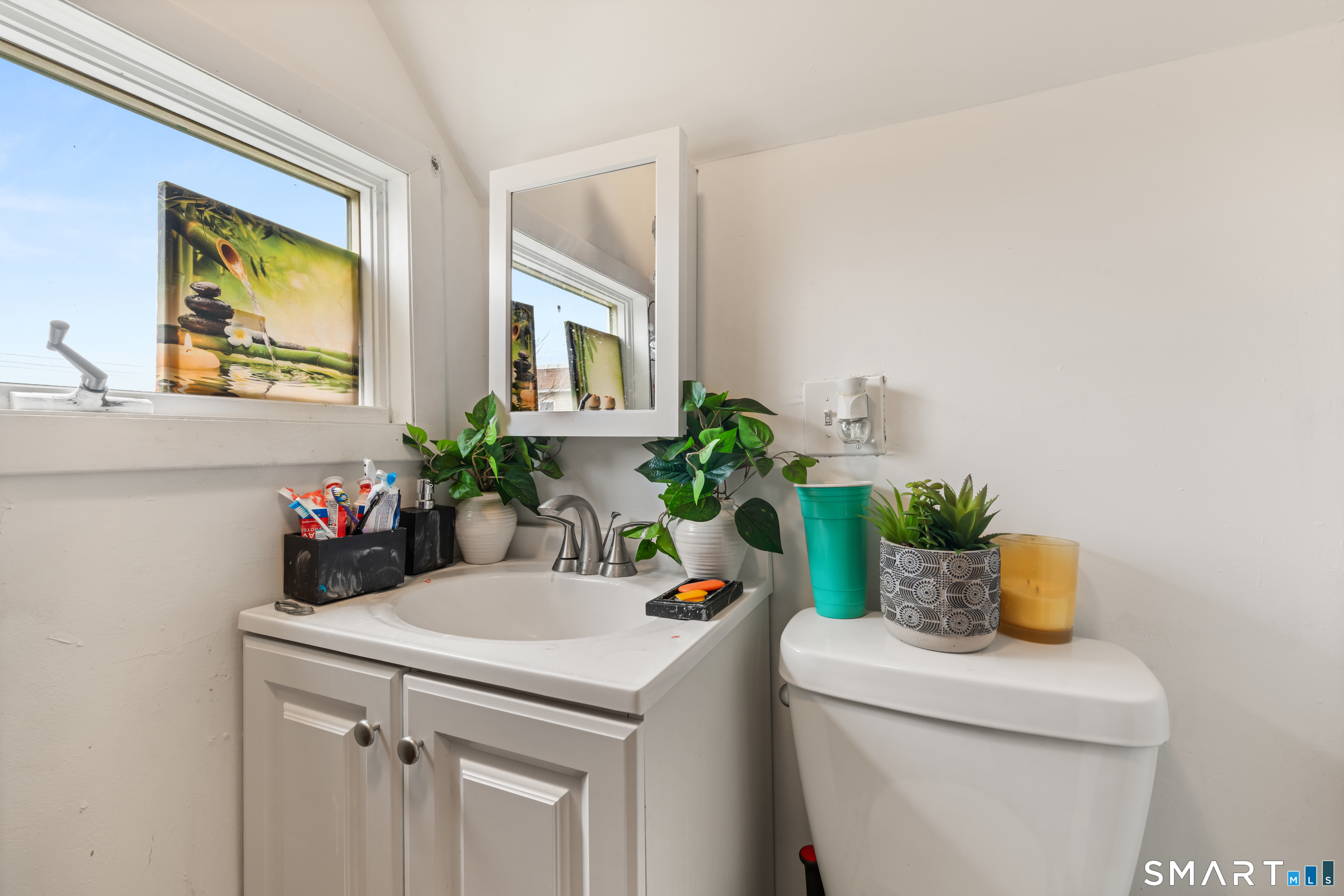 386 Huntington Road Bridgeport, CT 06608 - Photo 26 of 33 a bathroom with a sink a toilet and a mirror