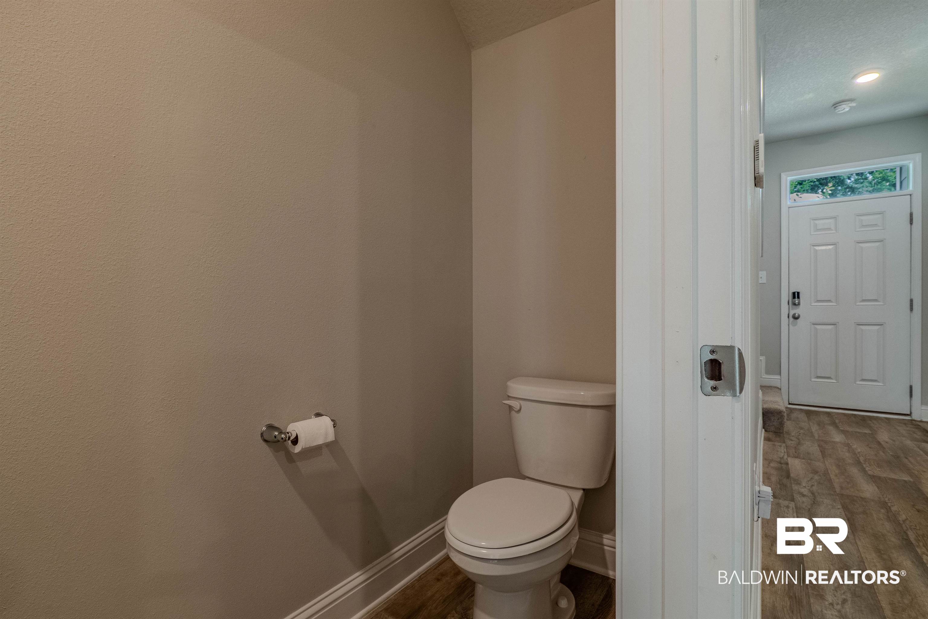 25806 Pollard Road, Unit 32 Daphne, AL 36526 - Photo 9 of 23 Bathroom with a textured ceiling, hardwood / wood-style floors, and toilet