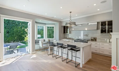 a kitchen with stainless steel appliances granite countertop a stove and a refrigerator