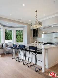 a kitchen with a counter space a sink cabinets and appliances