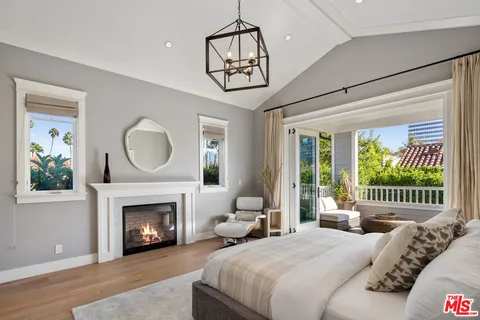 a bedroom with a bed and a fireplace